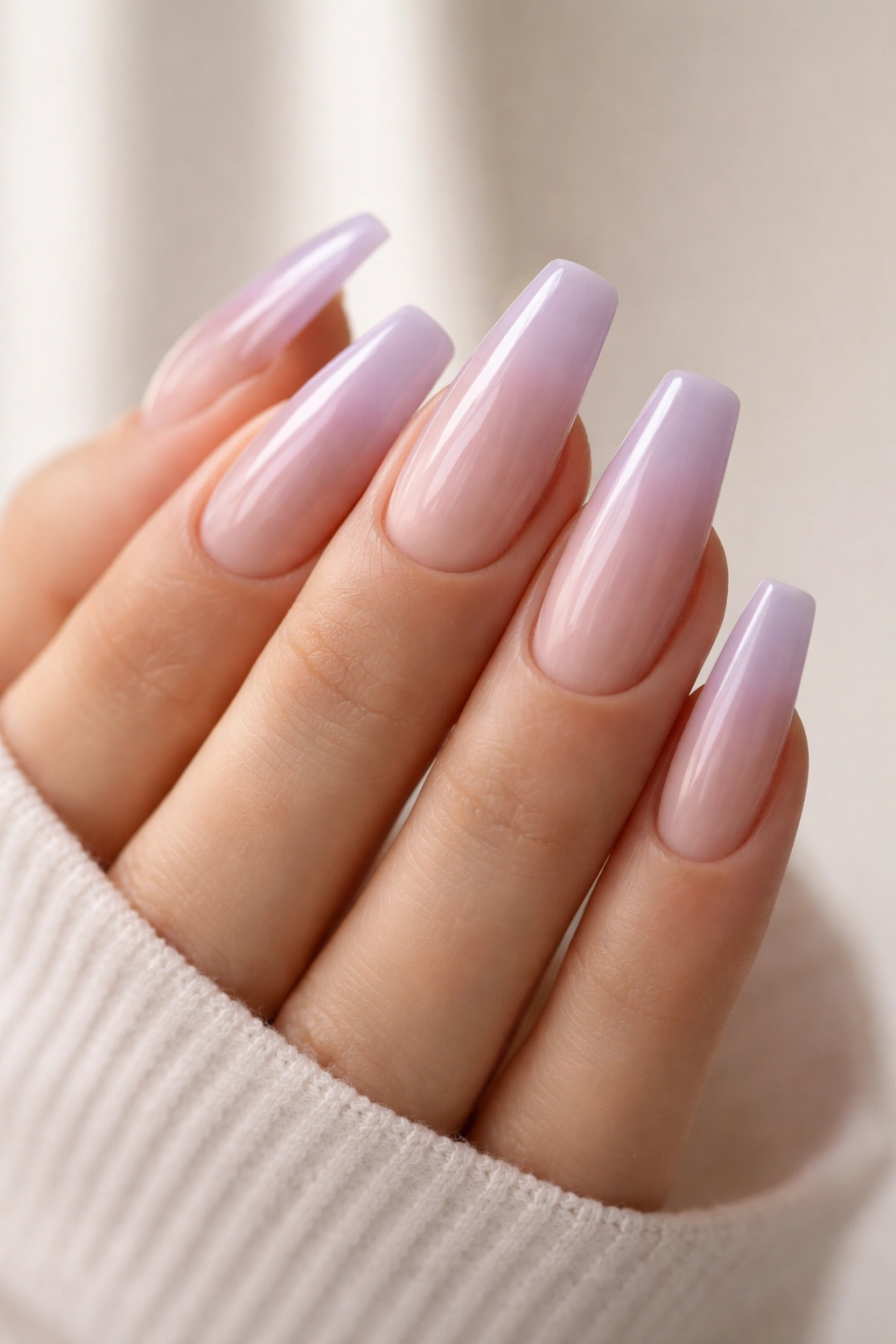 Coffin nails with milky lavender over nude base on medium length