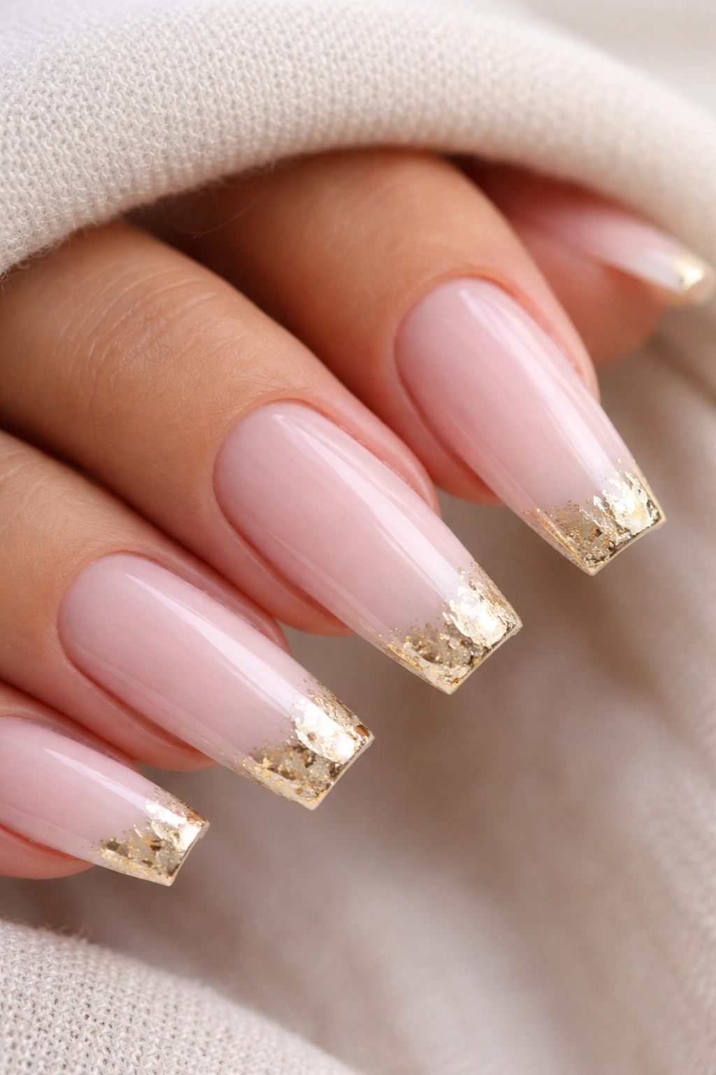 Milky pink ombré coffin nails with irregular gold foil tips