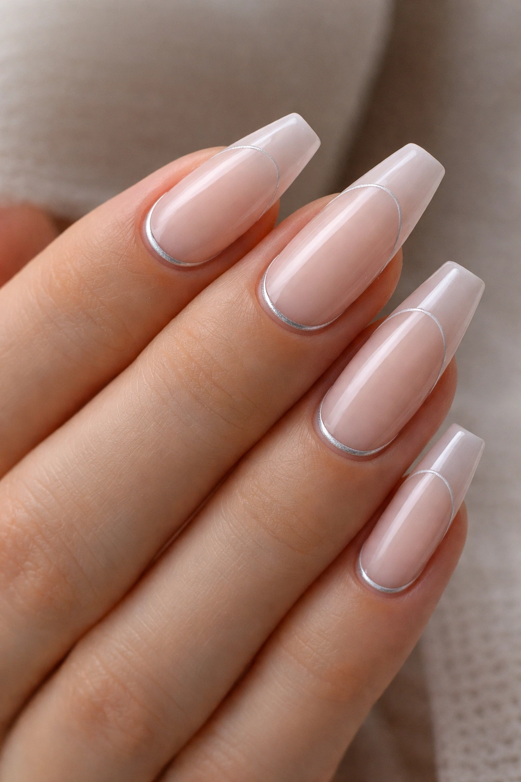 Nails with milky pink base and thin reverse line near the cuticle