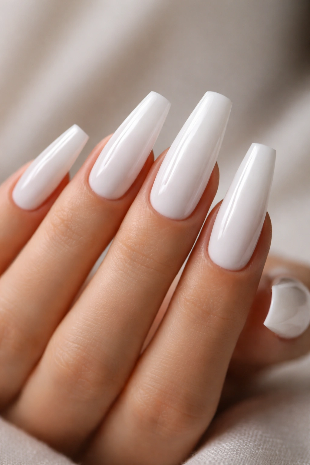 Close-up of pure milky white coffin nails with glass finish