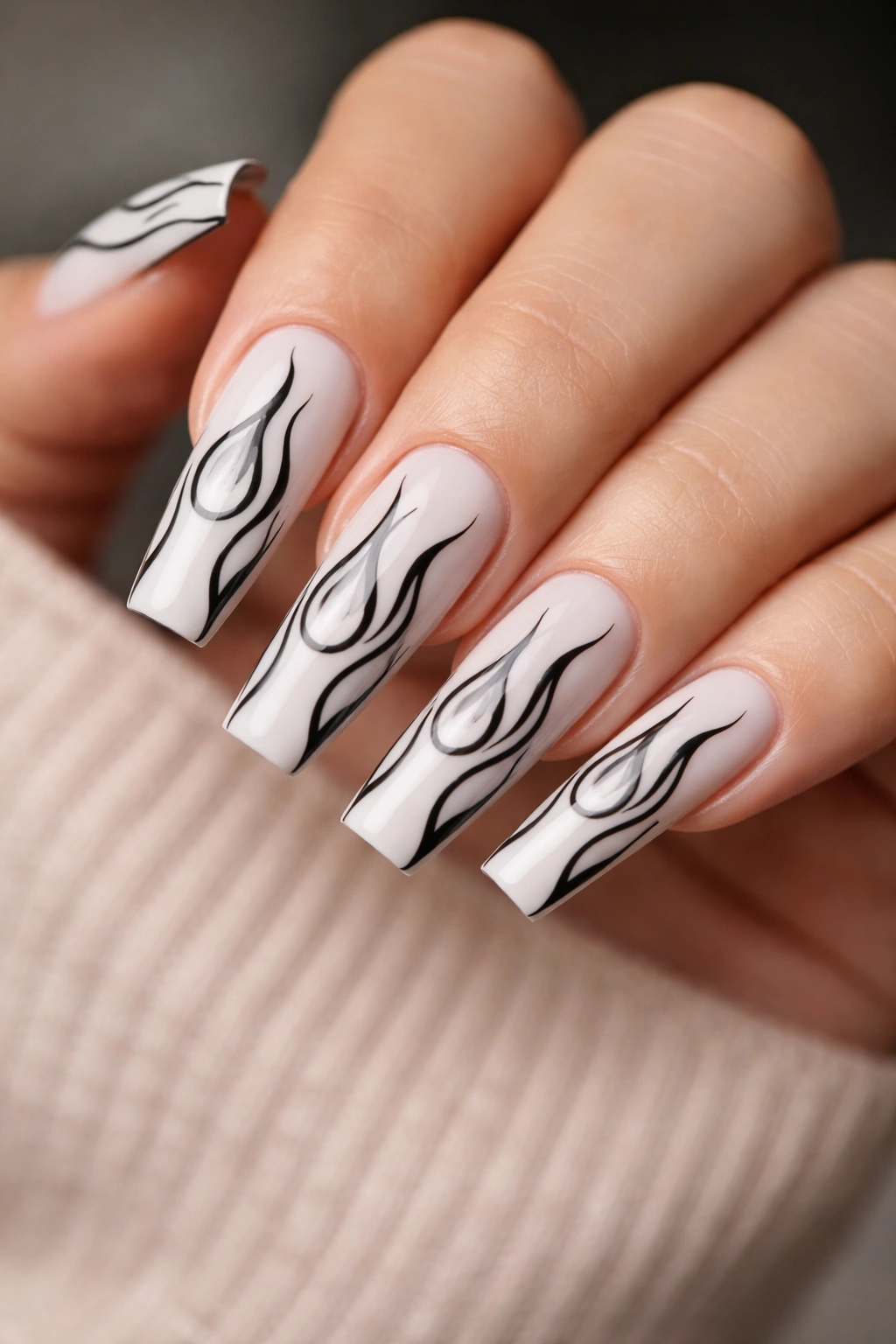 Milky white coffin nails with black outlined flames.