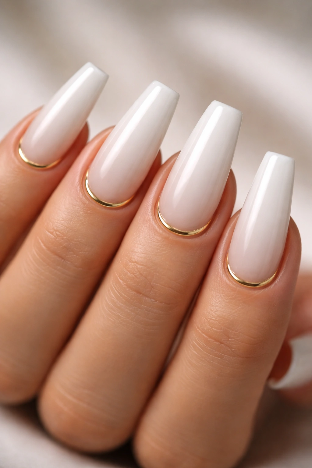 Coffin nails with milky white base and gold cuticle half-moons