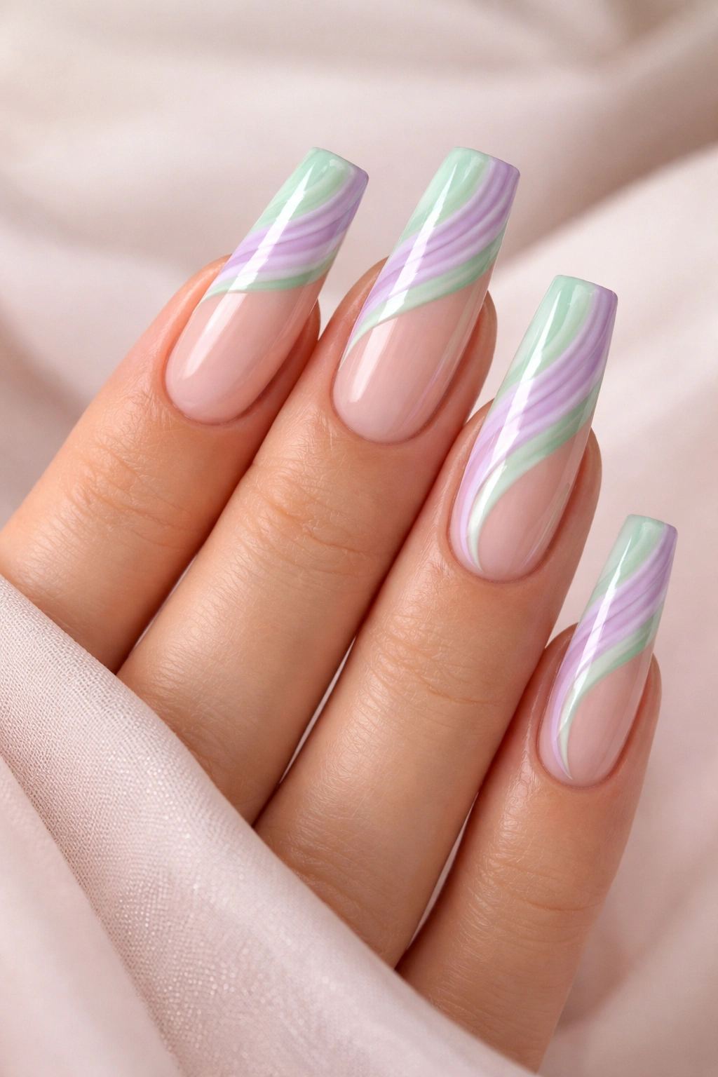 Coffin nails with mint and lilac swirl patterns on sheer pink base