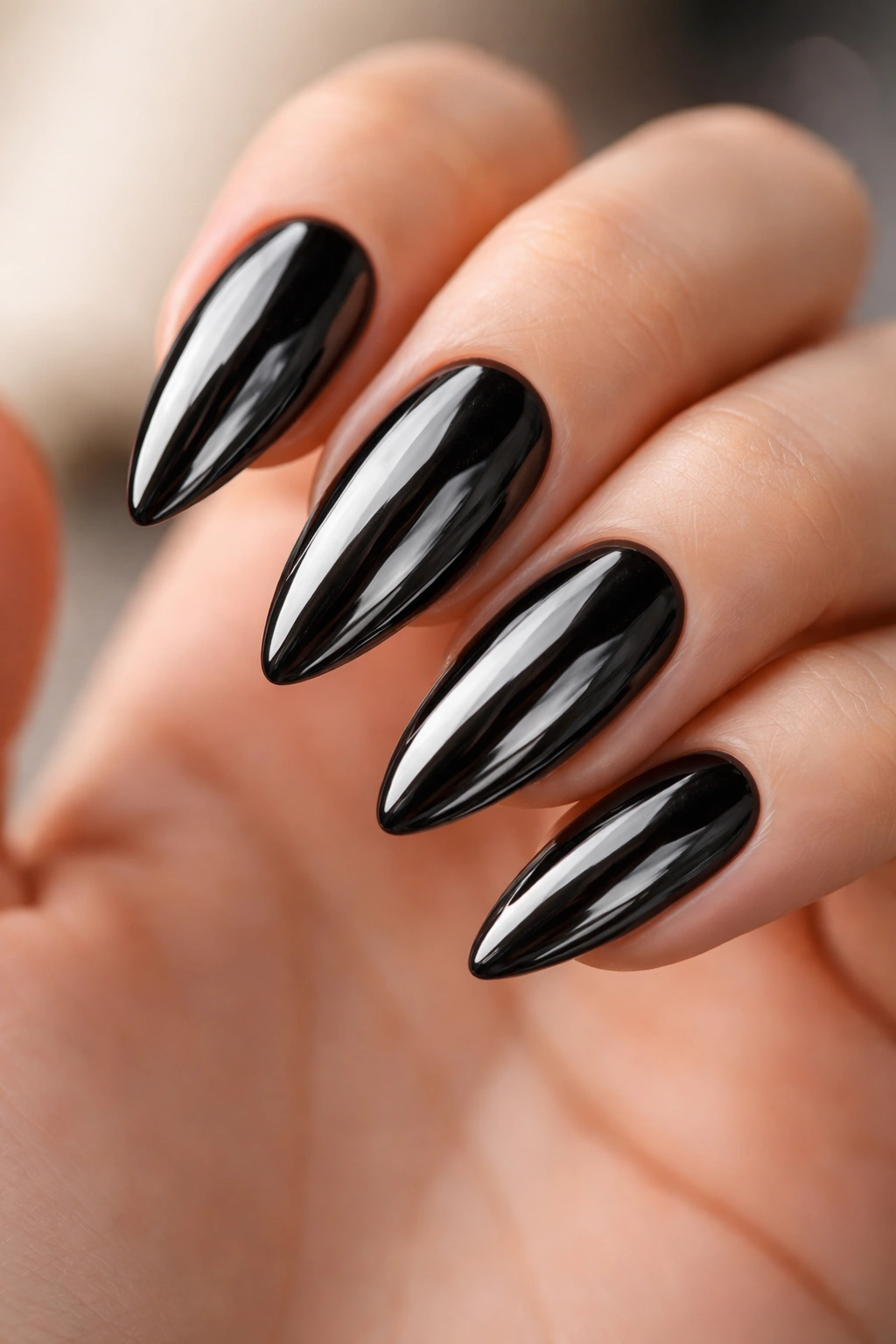 Almond nails with full-mirror black chrome on a jet-black base, ultra-glossy finish