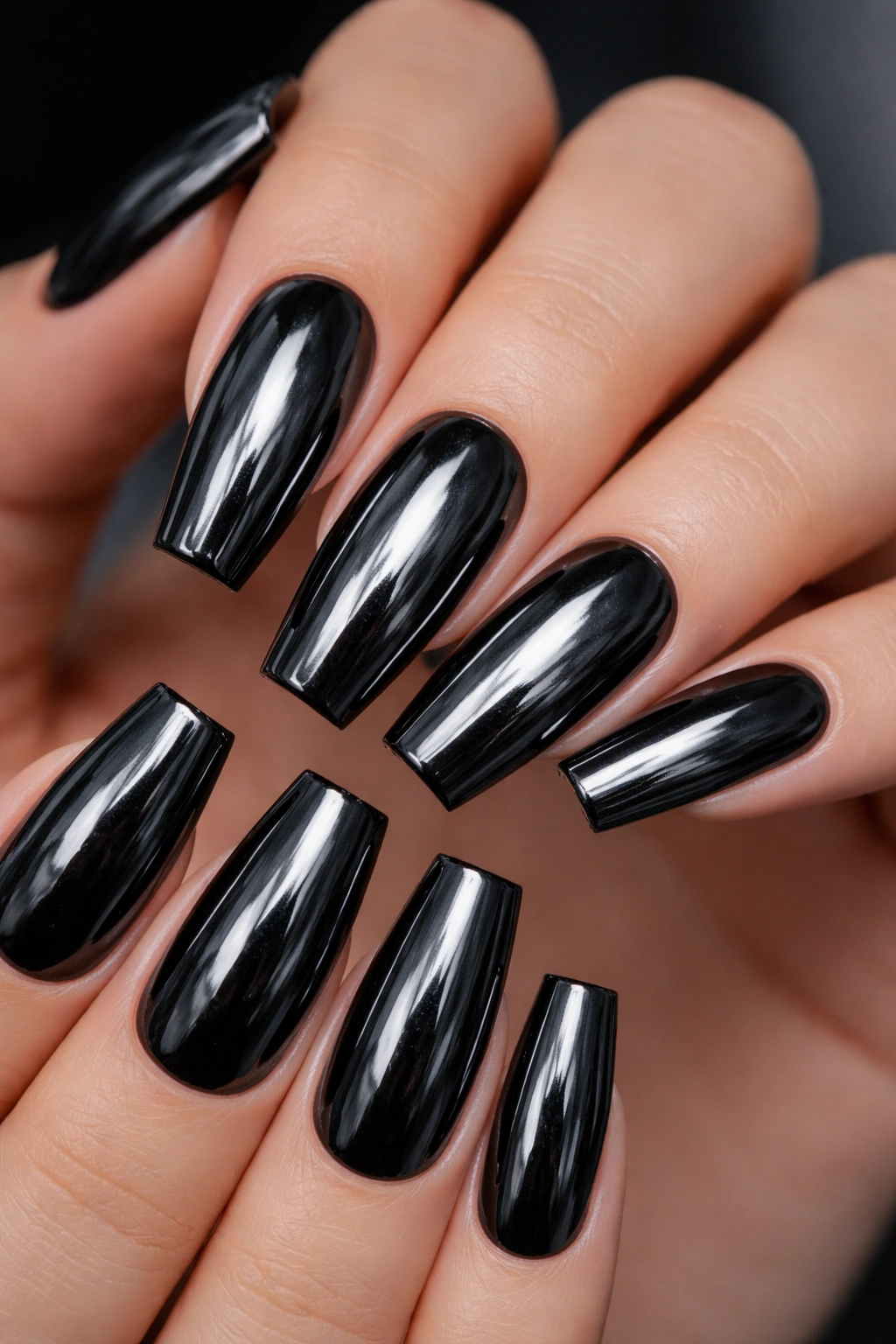 Close-up of mirror-finish black chrome coffin nails on a medium-to-long coffin shape