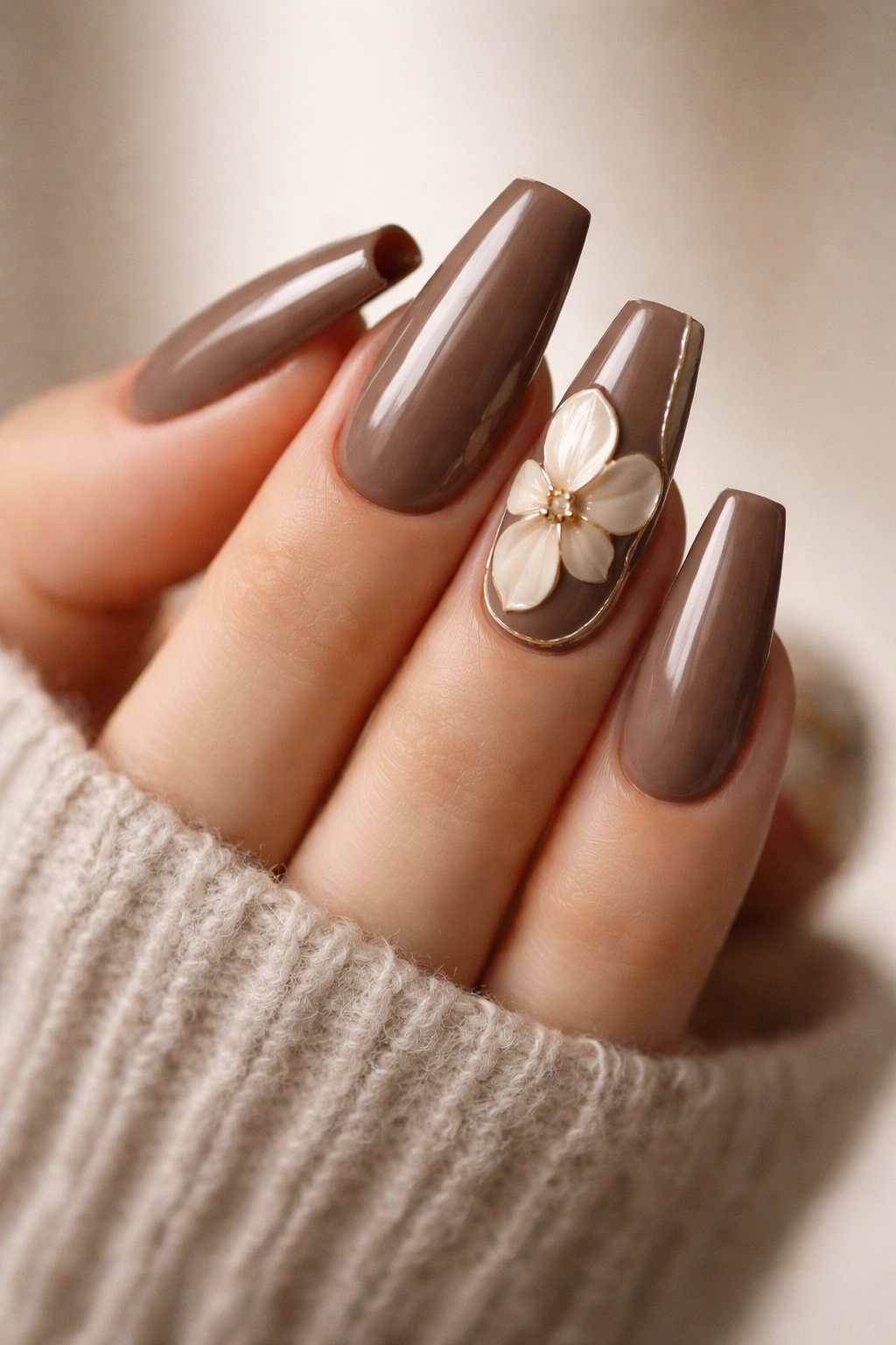 Mocha coffin nails with gold-framed petals and subtle gold accents.