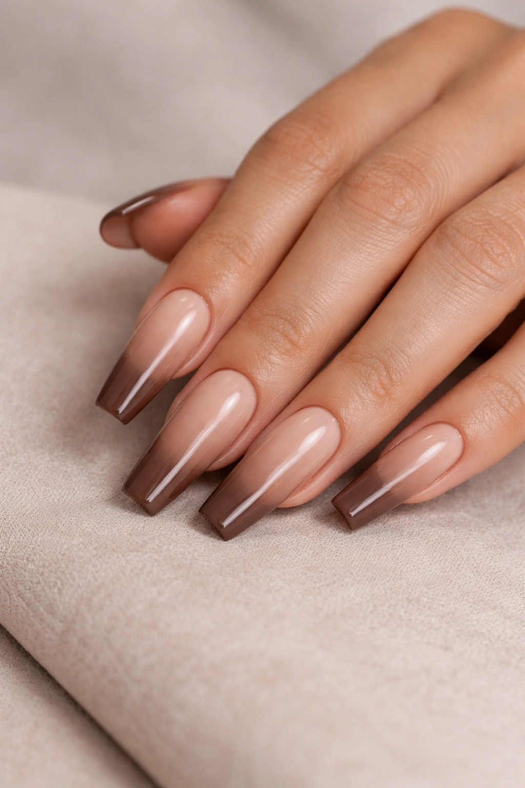 Close-up of mocha ombré coffin nails with beige-to-cocoa gradient on long coffin shape