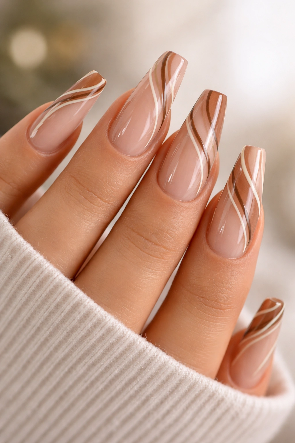 Mocha swirl coffin nails with cream lines on nude base