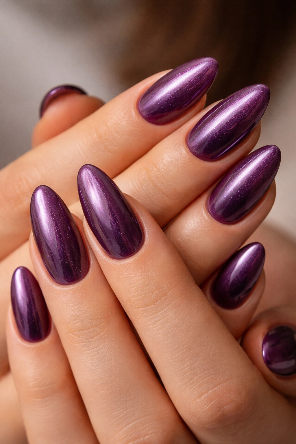 Almond nails with mulberry base and pearly glaze creating soft glow