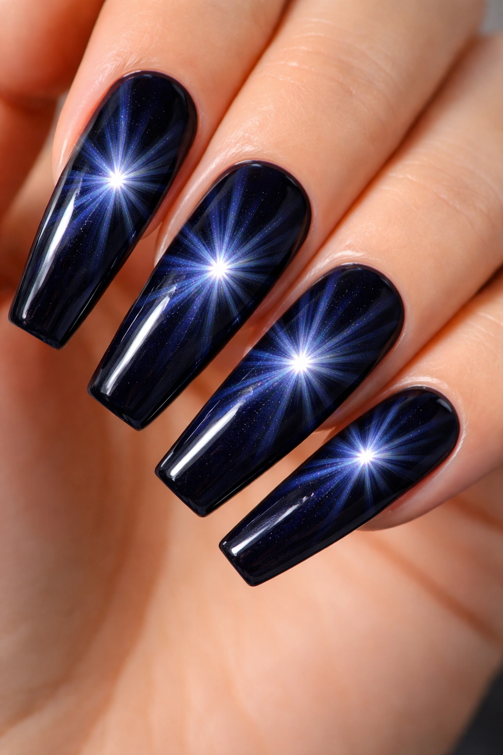 Deep navy cat-eye nails with starburst glow rays