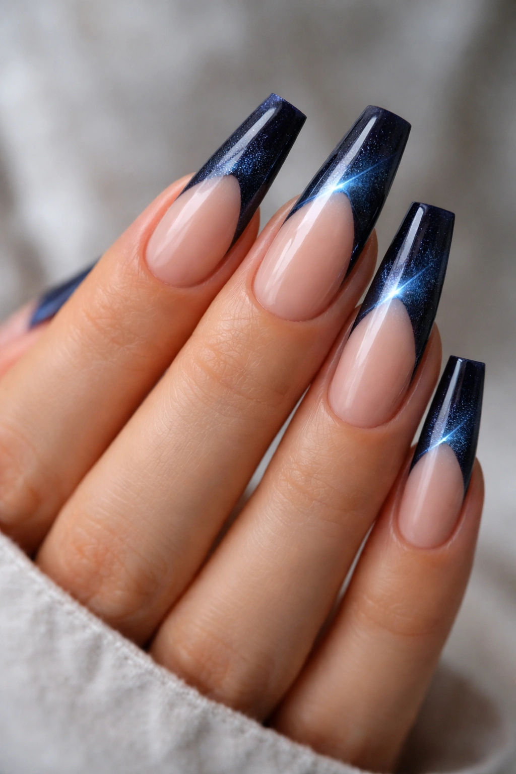 Navy velvet French tips with magnetic cat-eye shimmer on coffin nails