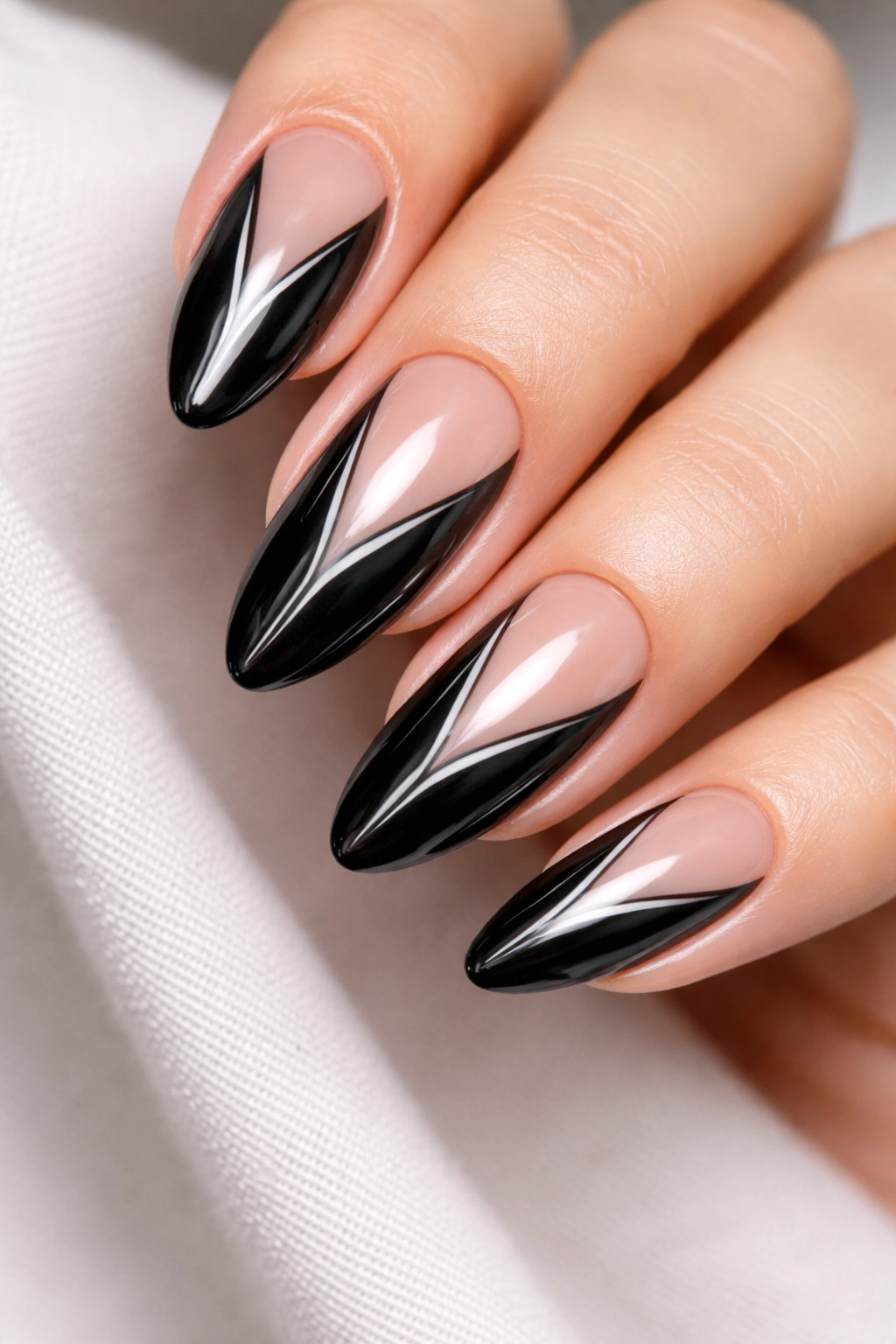 Negative-space black chrome almond nails with slim cutouts