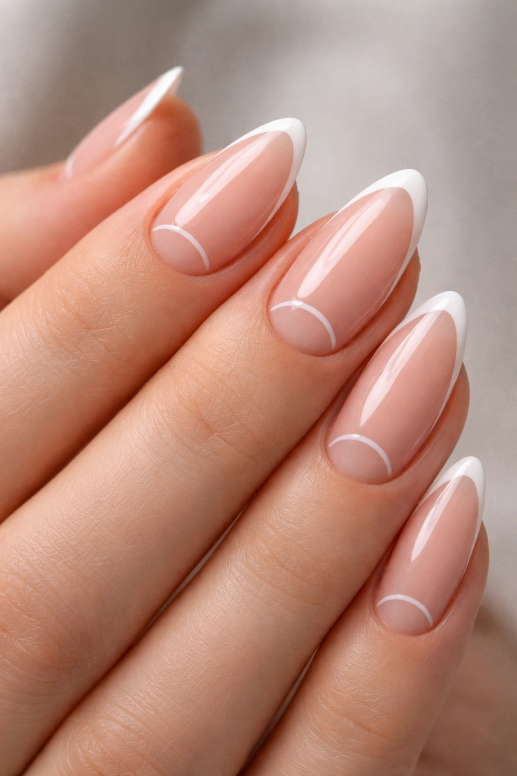 Close-up of almond nails showing negative-space cutout near the edge with a subtle outline.
