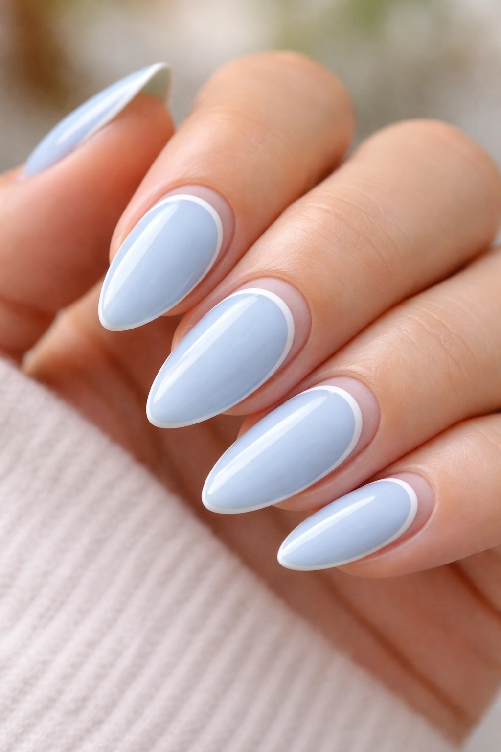 Almond nails with pastel blue and curved negative space