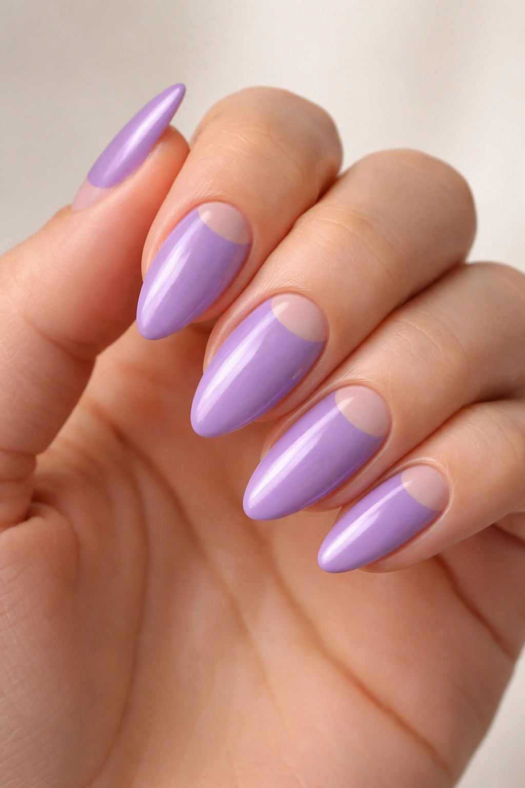 Almond nail with purple polish and crescent negative space at cuticle