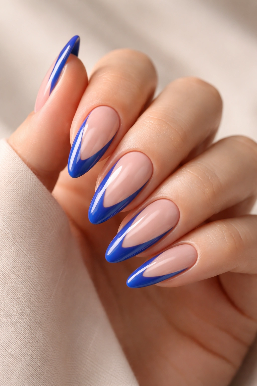 Almond nails with blue borders and negative-space cutouts