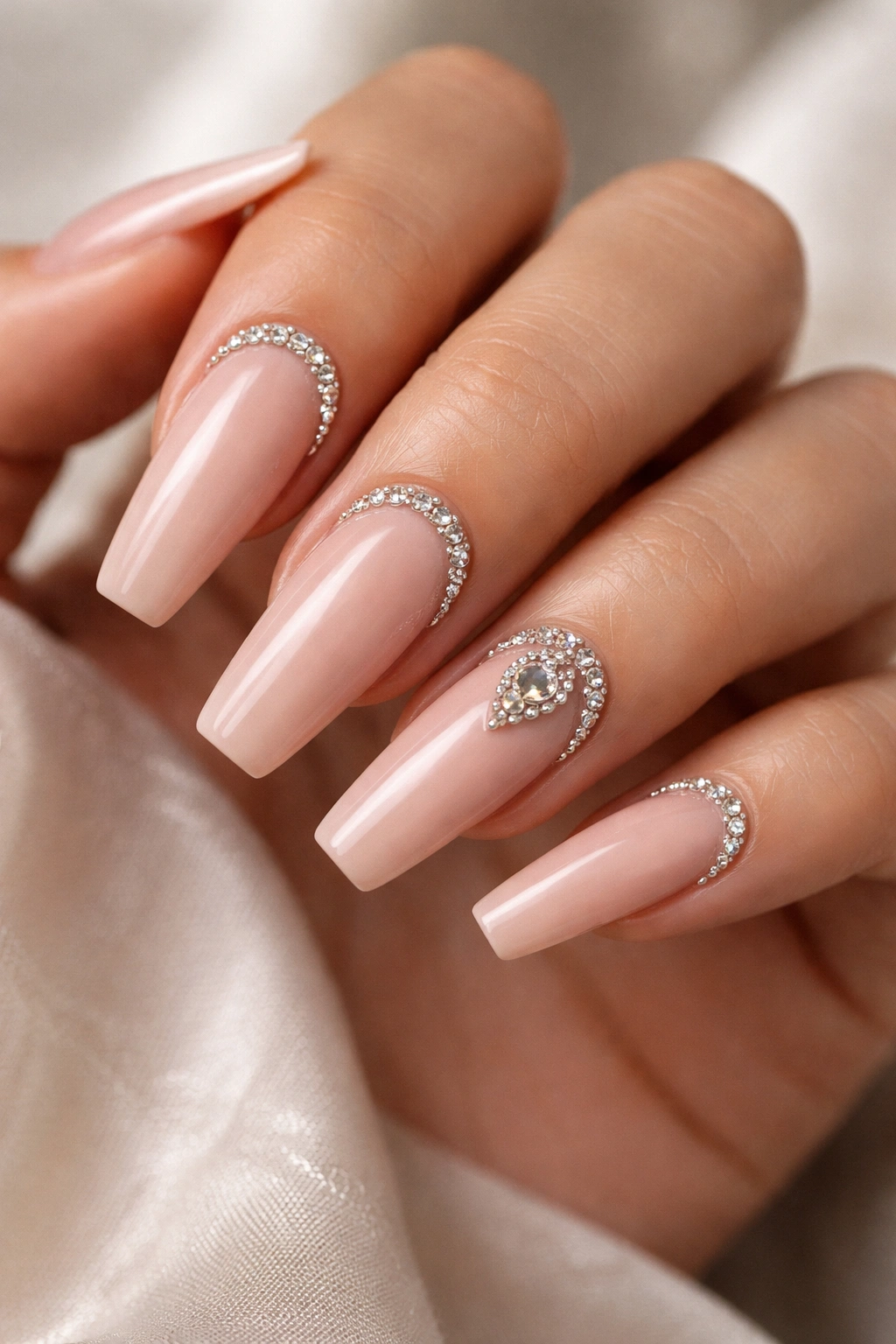 Nude coffin nails with crystal arches along the cuticle