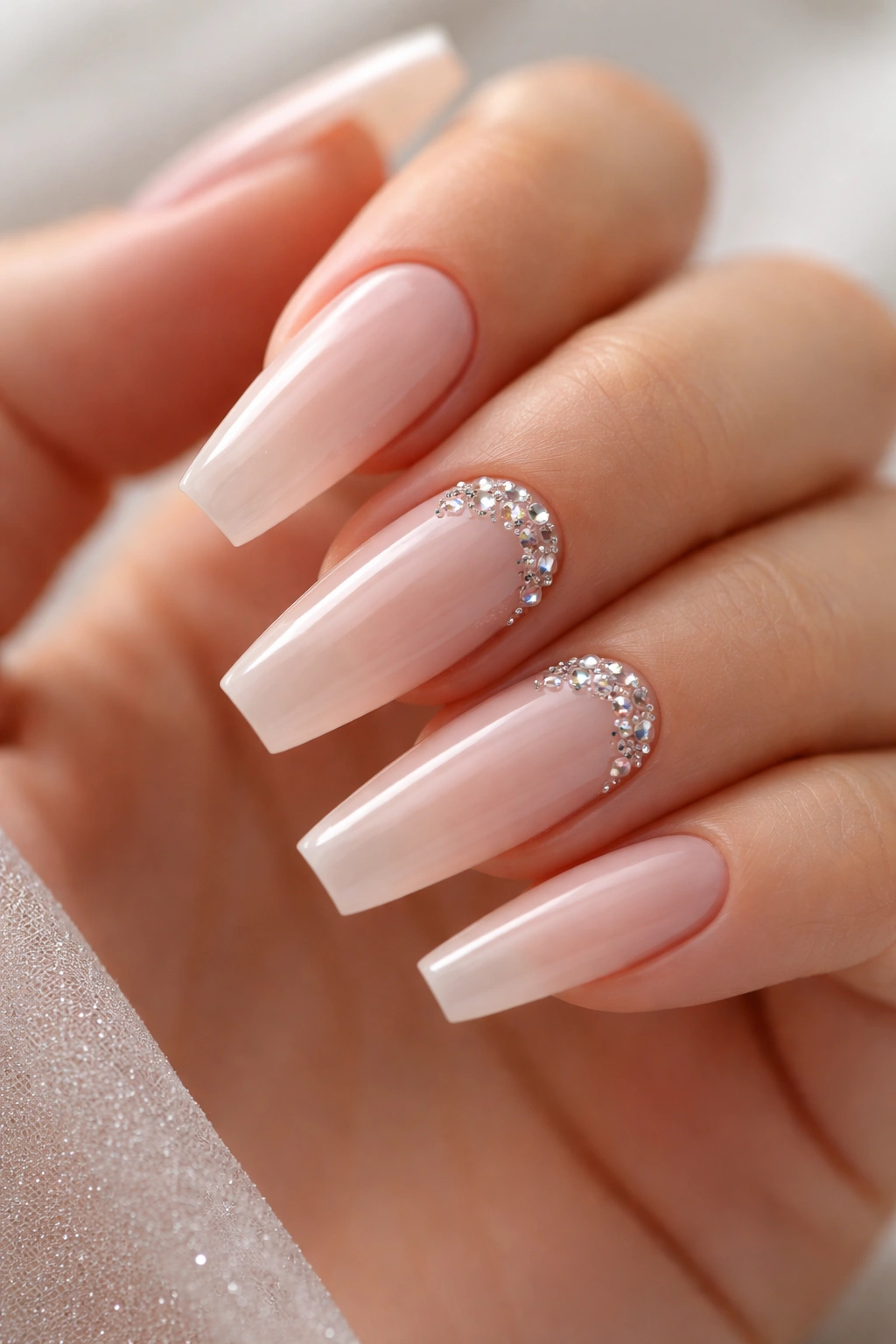 Barely-there nude coffin nails with micro crystals near the cuticles
