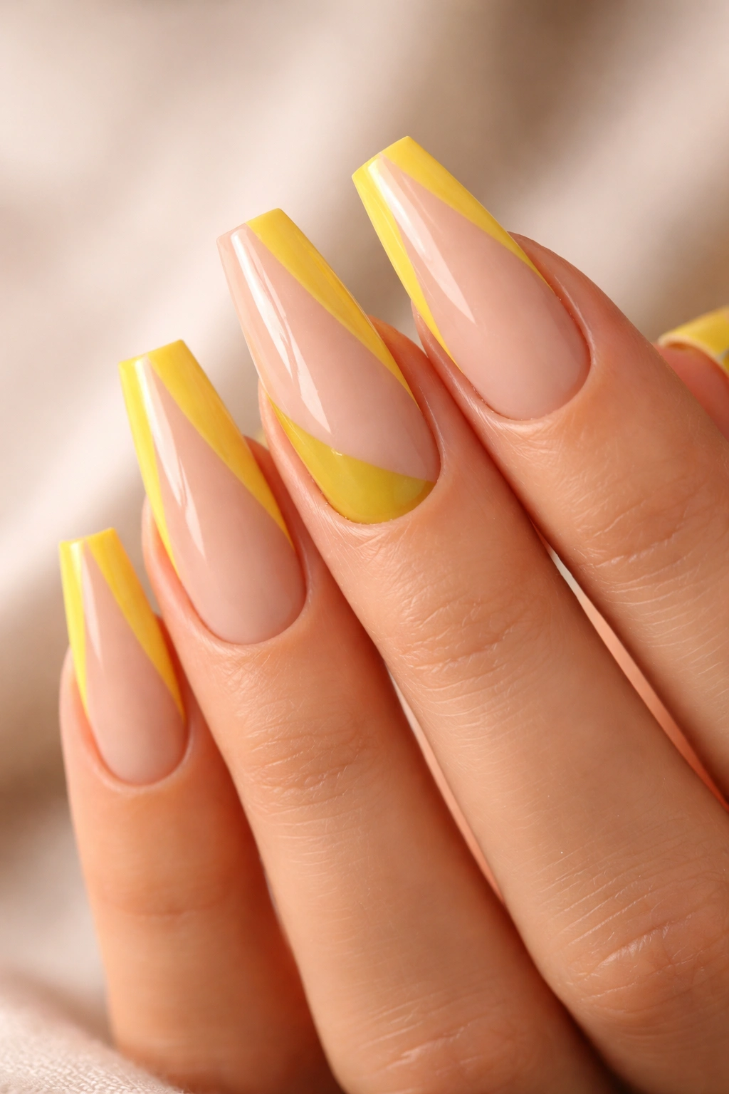 Close-up of nude and yellow color-block coffin nails with sharp diagonal and side-panel designs