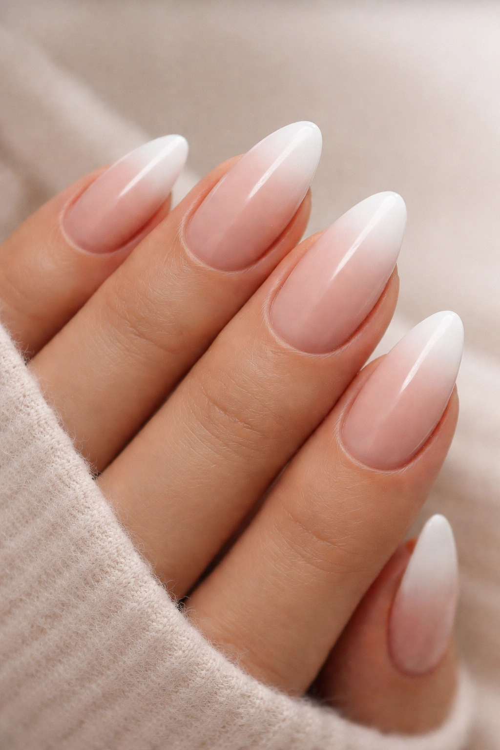 Almond nails with nude-to-white gradient at tip (ombré baby boomer)