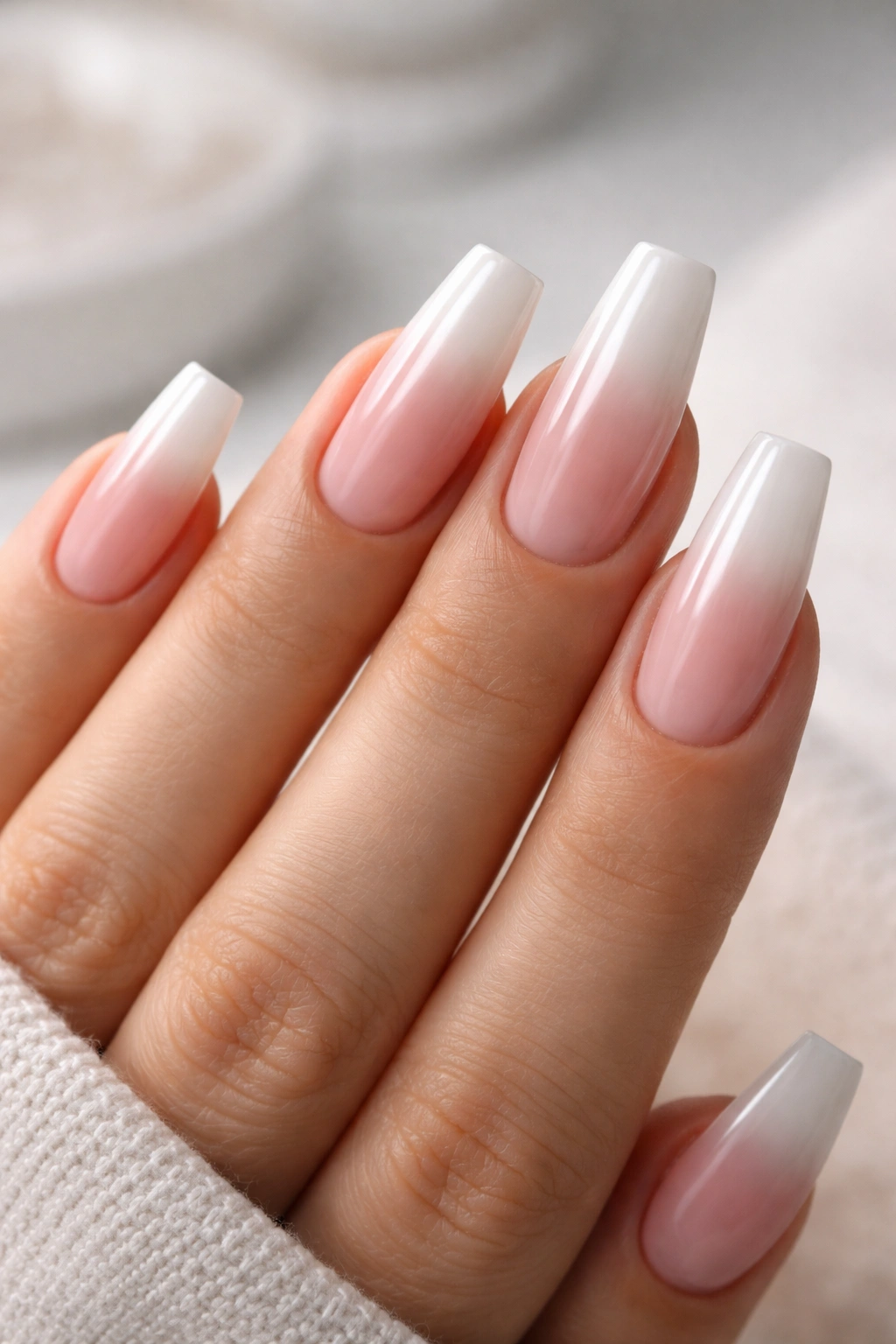 Hand with coffin nails showing a smooth ombre created by thin sheer layers