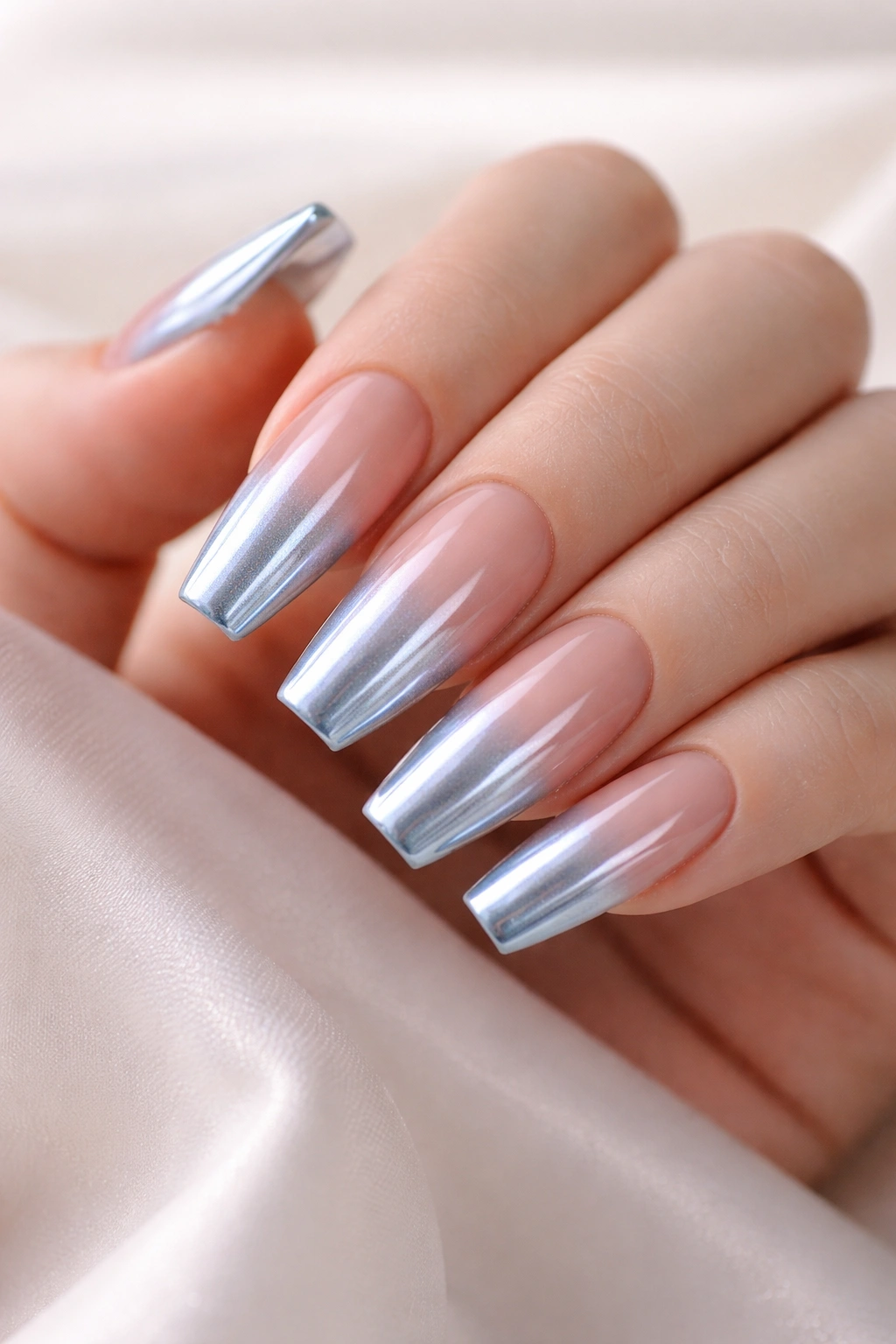 Close-up of Nude-to-Blue Chrome Ombre on coffin nails with soft cuticle fade