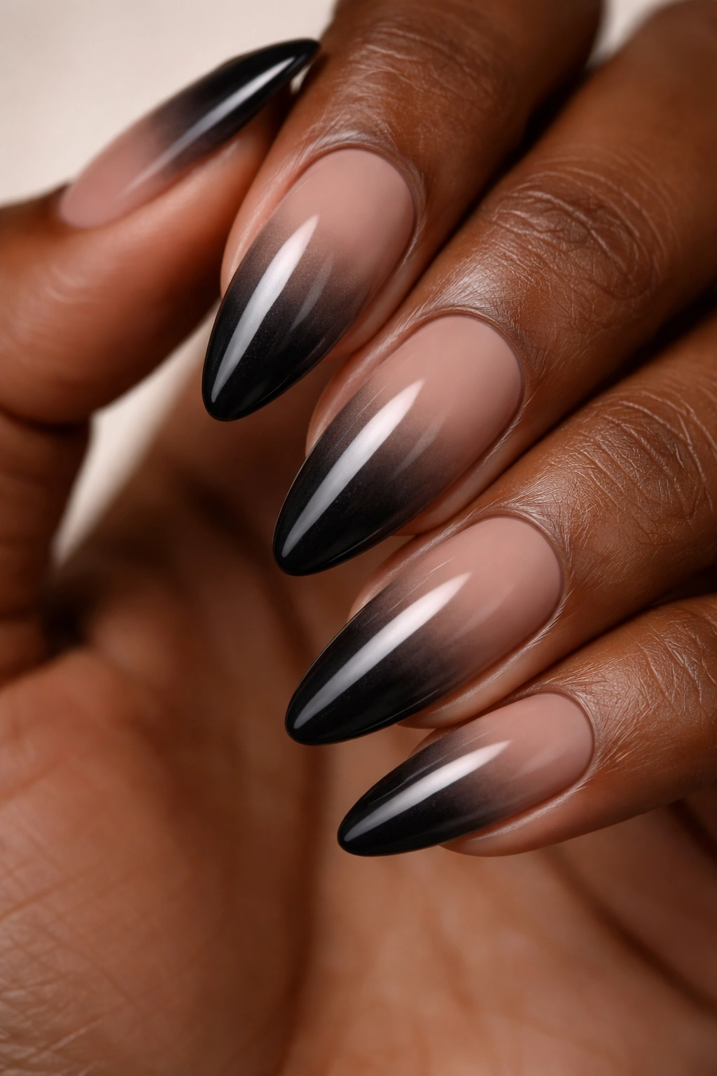 Smoky ombre on almond nails from nude to black