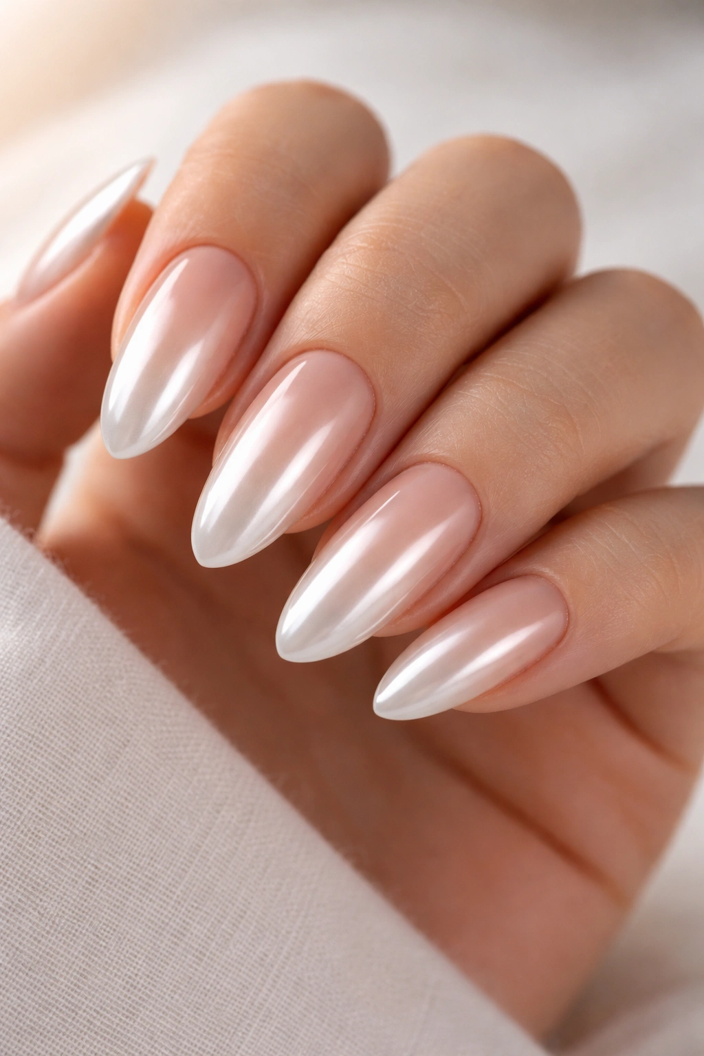 Almond nails with nude to white chrome ombré gradient