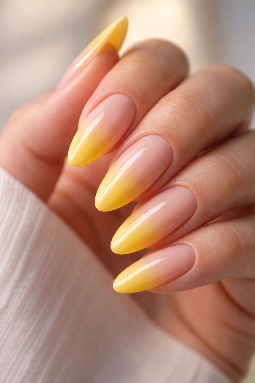 Almond nails with nude to yellow ombré gradient