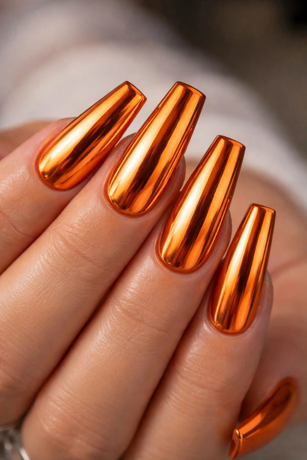 Orange chrome coffin nails with glossy mirror finish