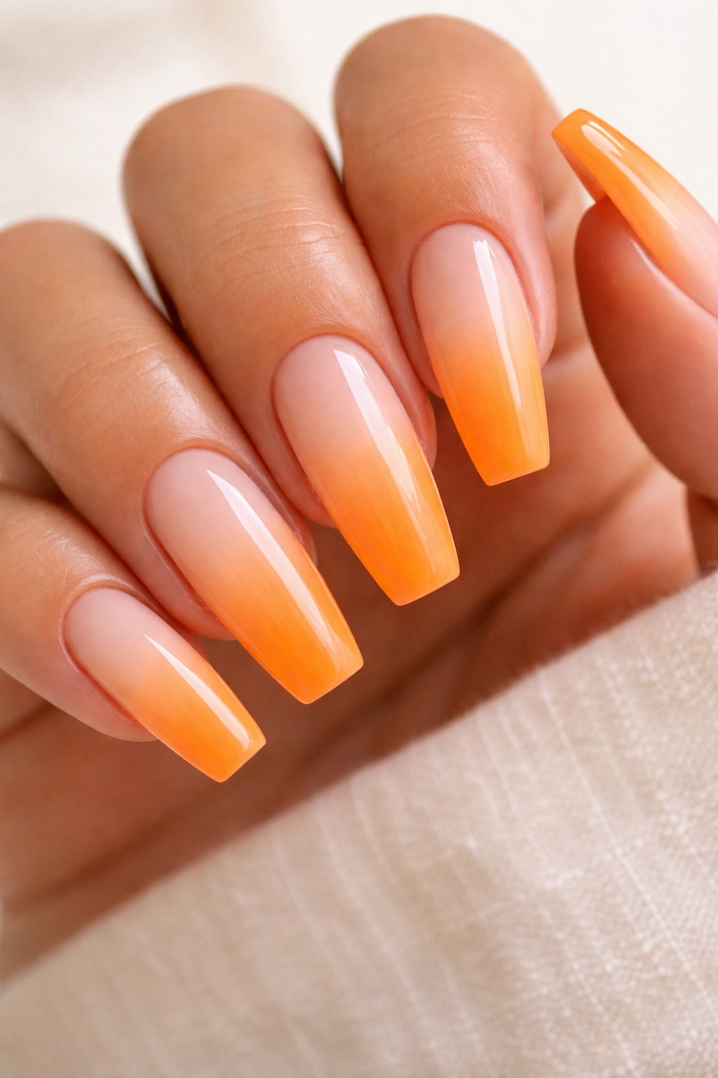 Orange creamsicle ombré coffin nails with milky peach to orange gradient