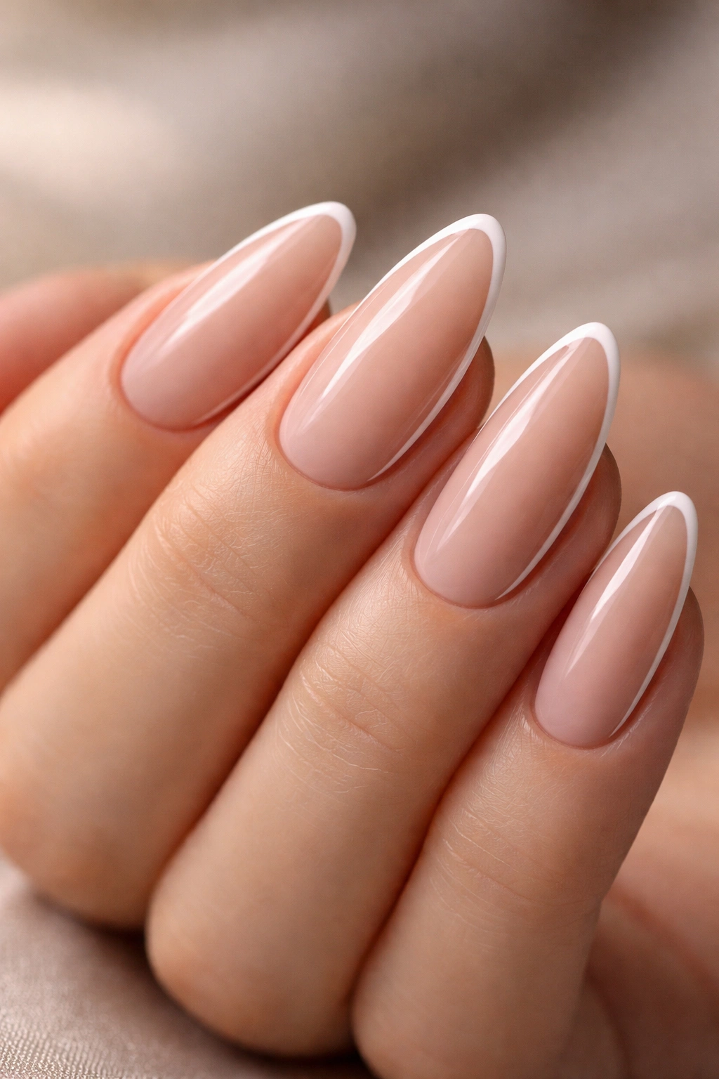 Almond nails with a thin white border along the edge on nude base