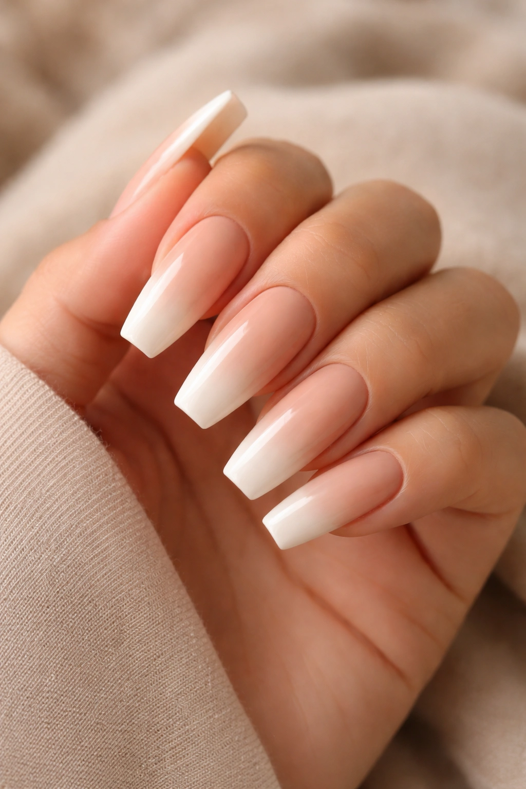 Close-up of peach nude coffin nails with a cream tip