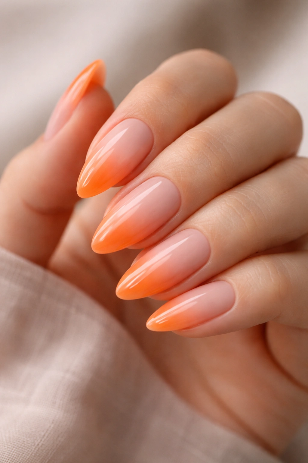 Almond nails with peach to tangerine gradient