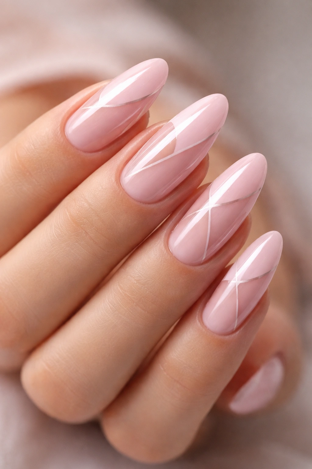 Close-up of almond nails with petal pink and negative-space design