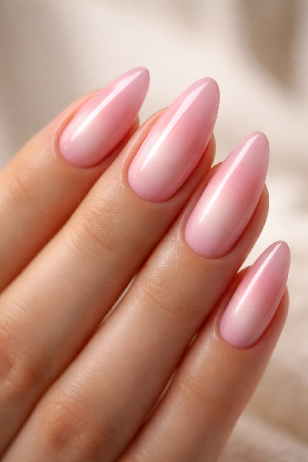 Close-up of pink aura almond nails showing center glow and edge contrast