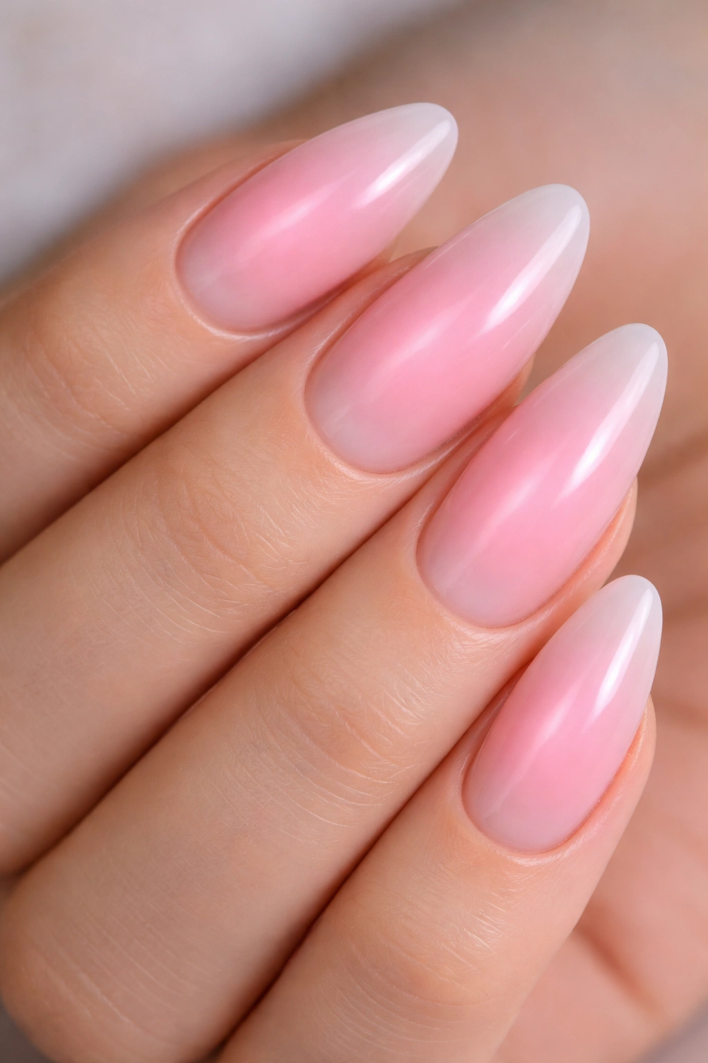Close-up of pink aura nails with center bloom on almond nails