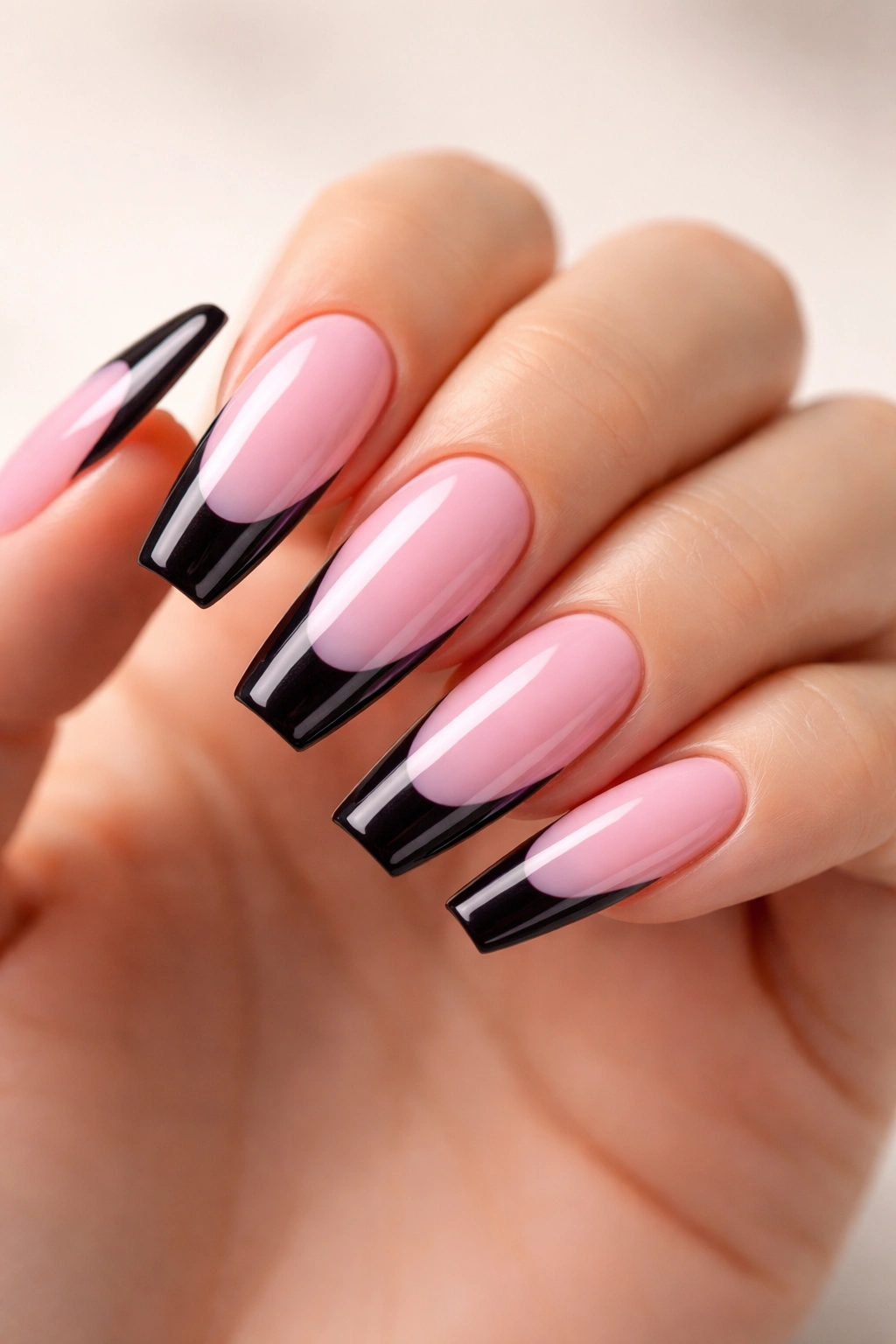 Close-up of pink coffin nails with dark tips for architectural contrast