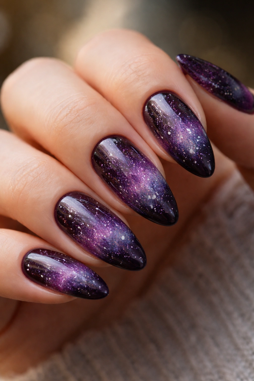 Plum galaxy almond nails with smoky gradient and glitter