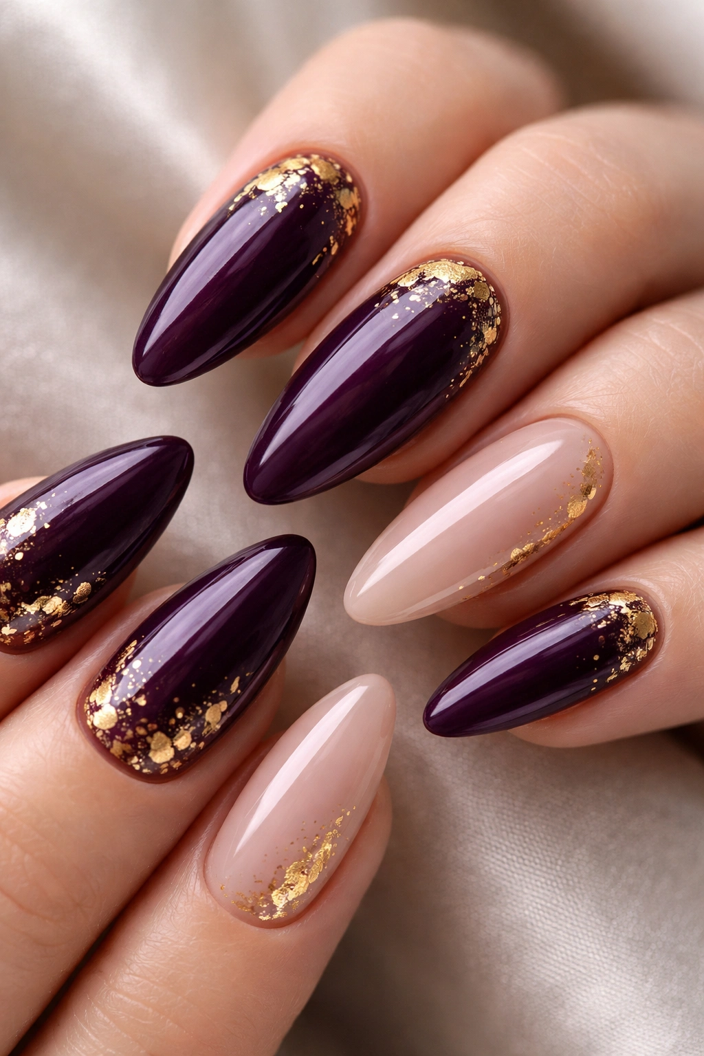 Plum almond nails with gold foil flecks