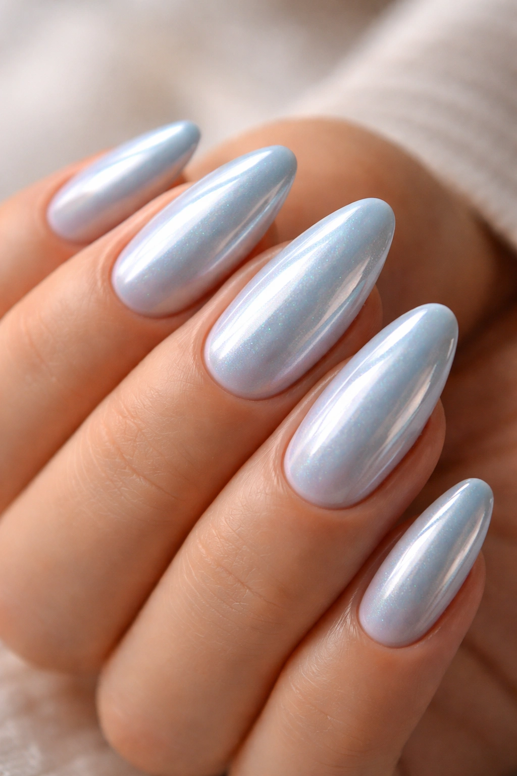 Almond nails with powder blue glaze and chrome sheen