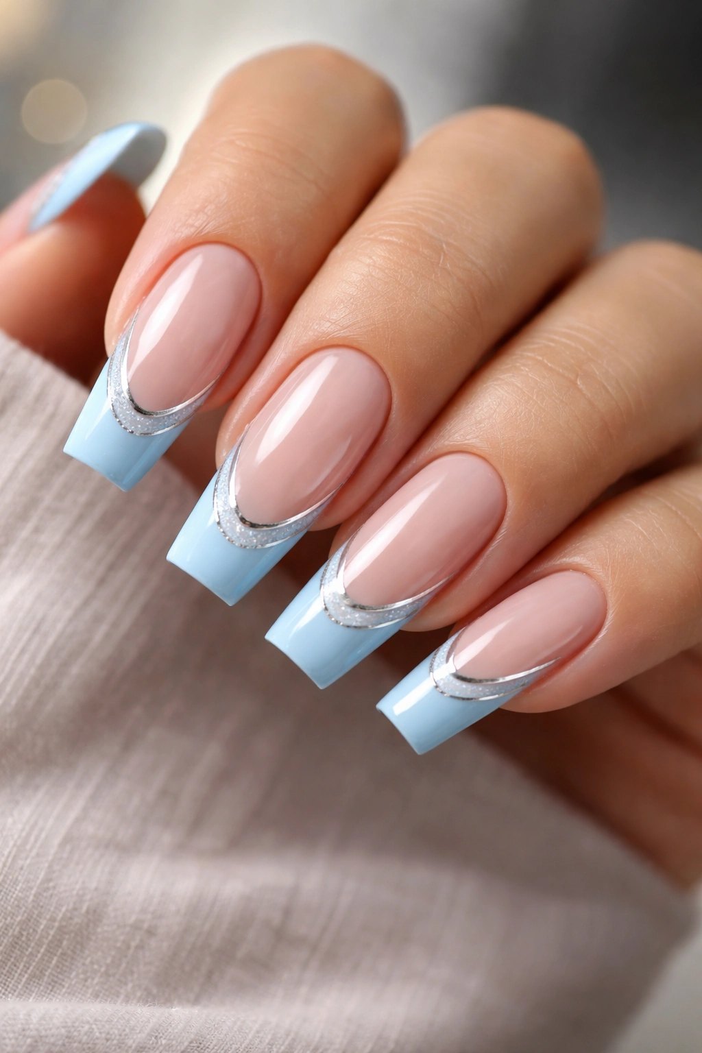 Powder blue double French tips with silver divider line on coffin nails
