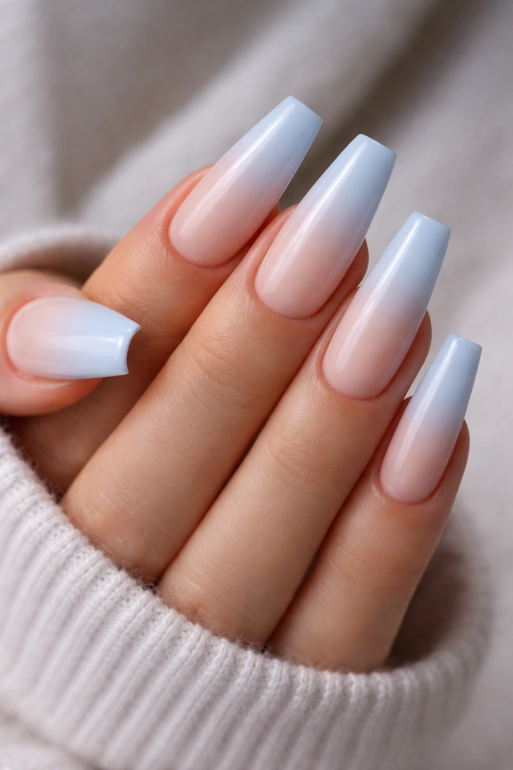 Coffin nails with powder blue ombré gradient from nude to blue