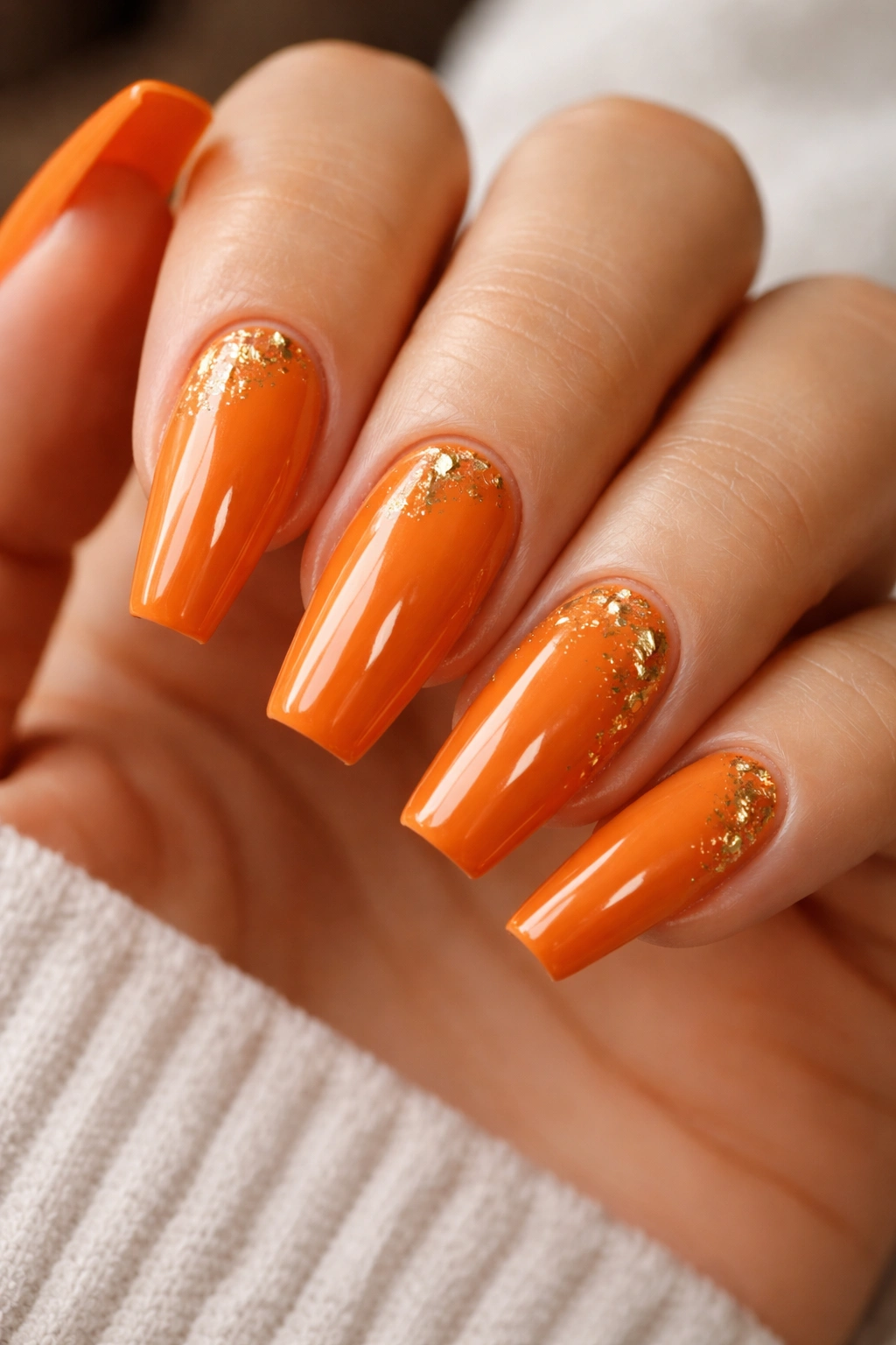 Pumpkin orange coffin nails with scattered gold foil accents