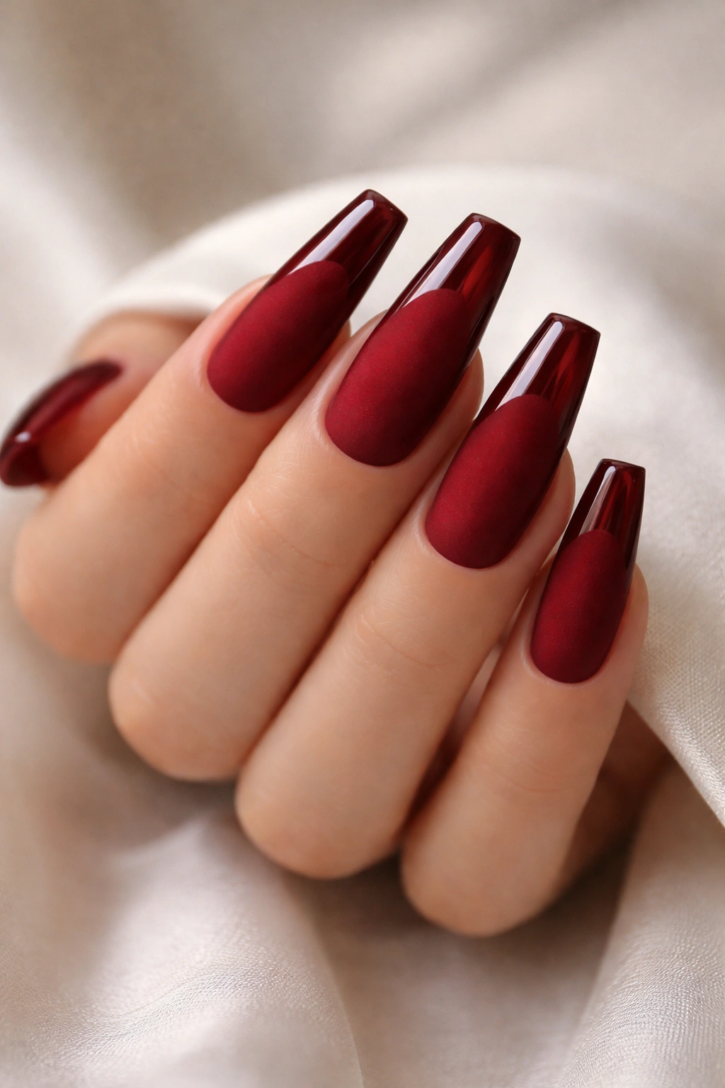 Close-up of red velvet matte coffin nails with glossy tips