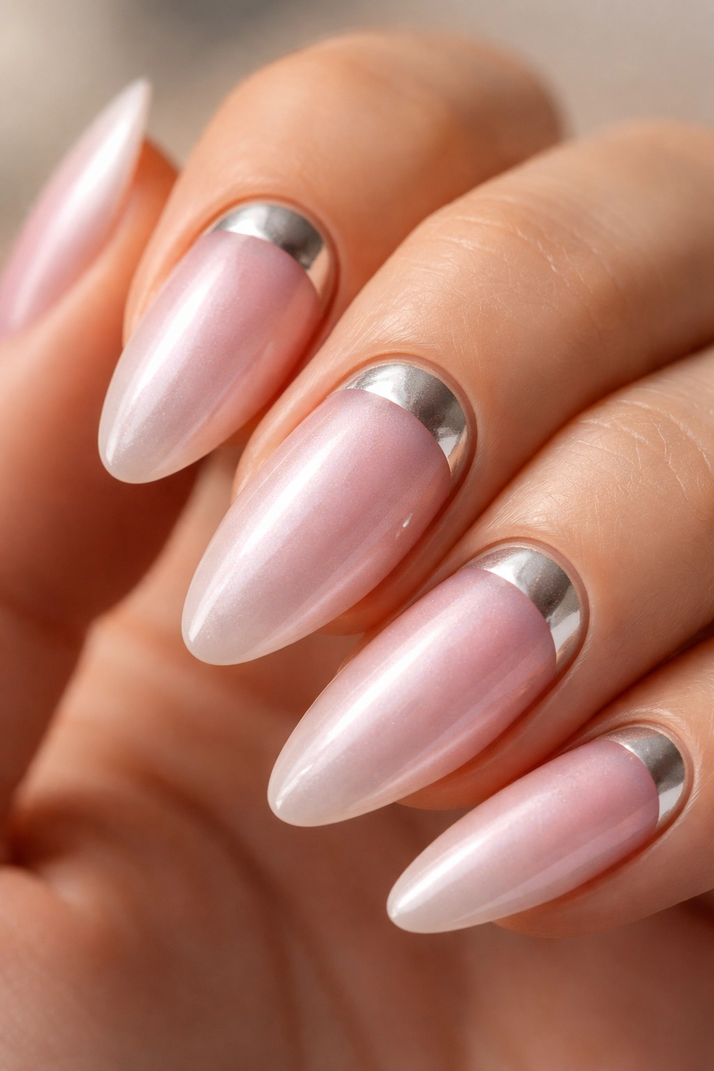 Almond nail with chrome moon at cuticle and pink chrome body.