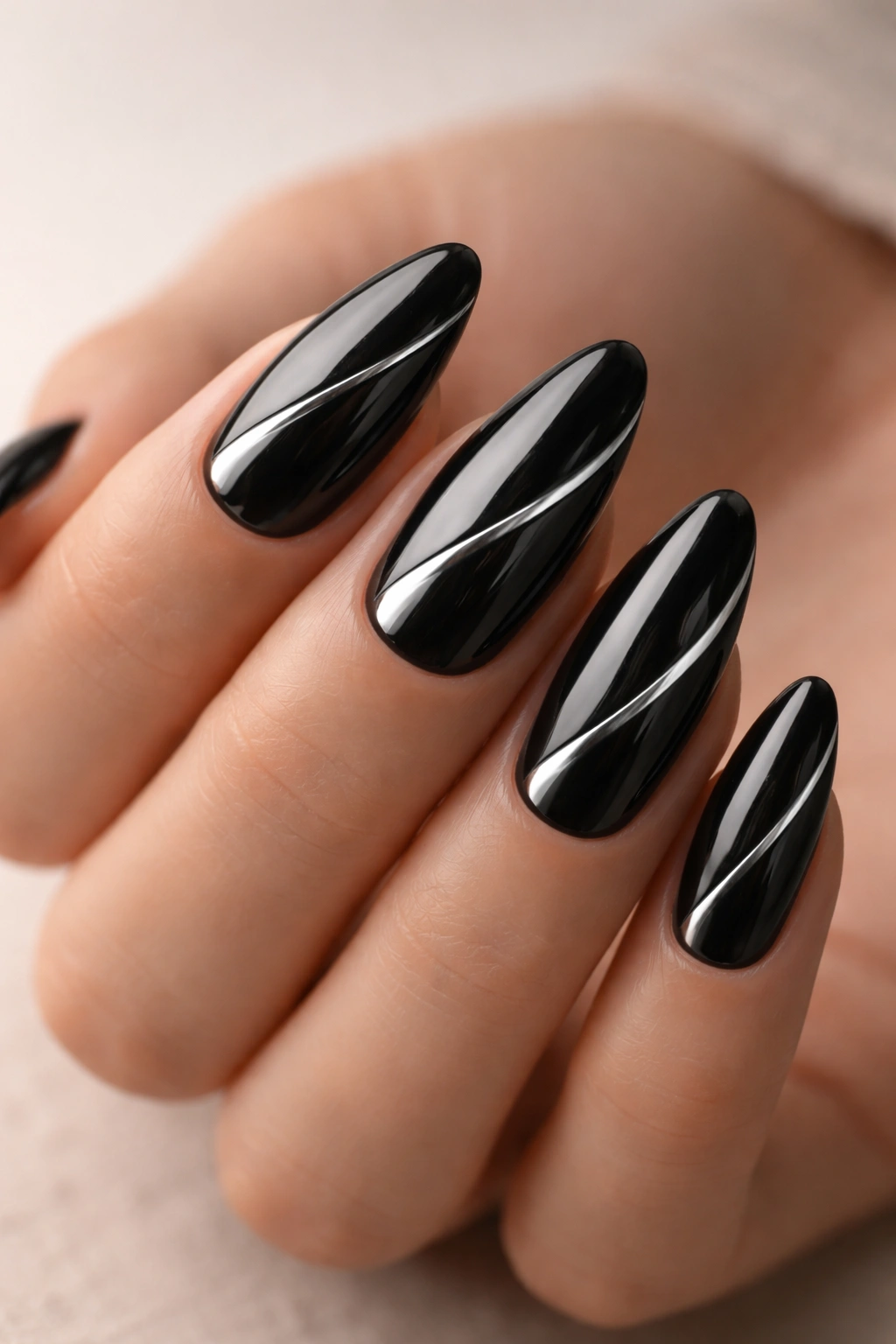 Almond nails with a delicate curved ribbon-line in black chrome