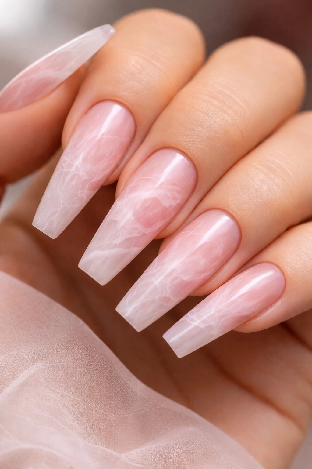 Rose quartz marble coffin nails with pink and white veining on long coffin nails
