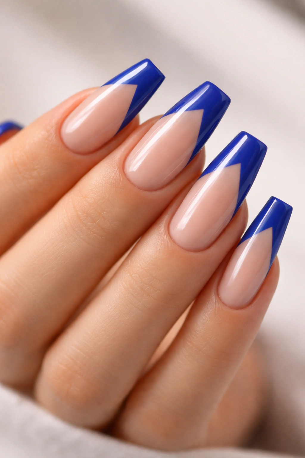 Coffin nails with diagonal royal blue French tips and negative space