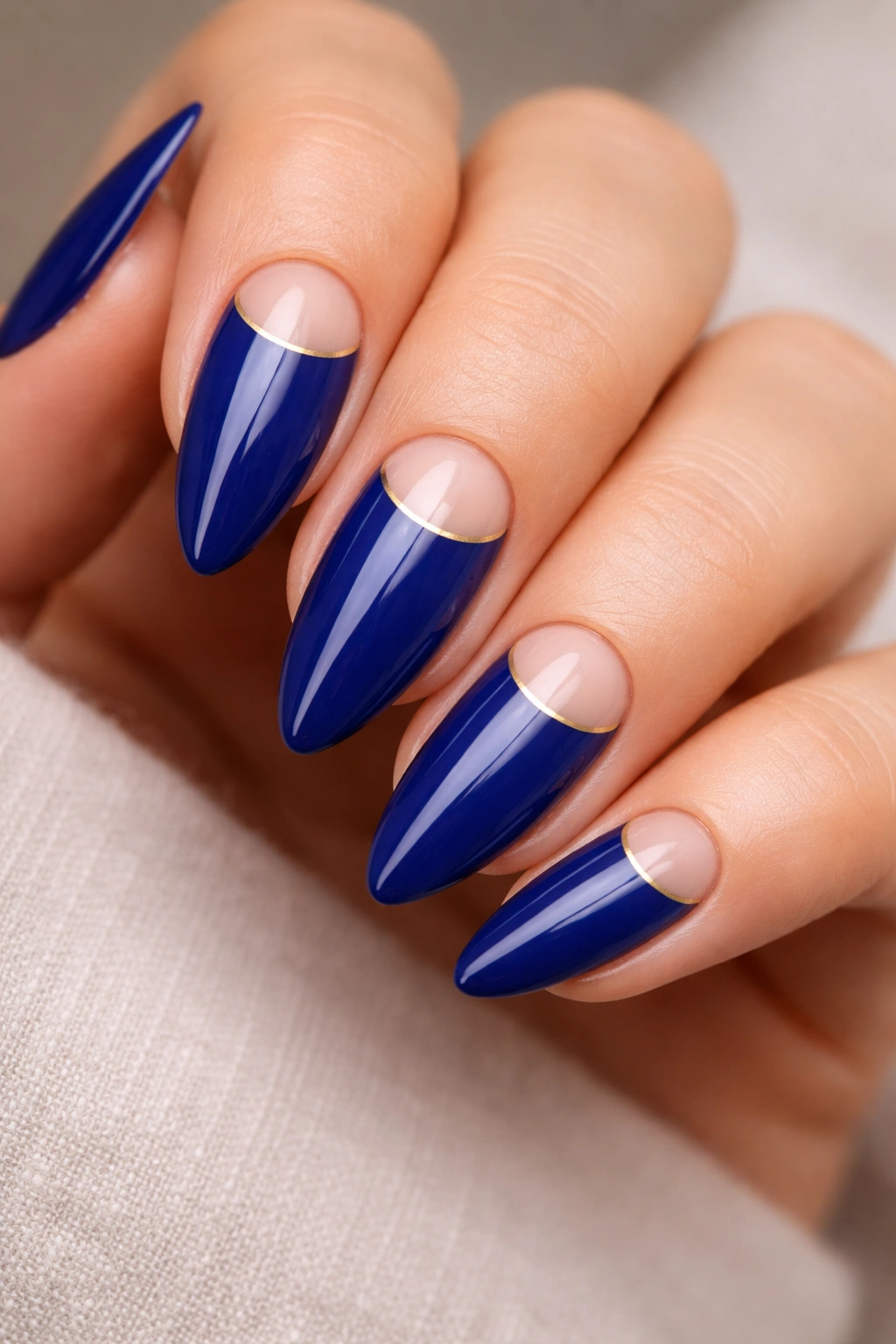 Almond nails with deep royal blue and nude half-moon at base